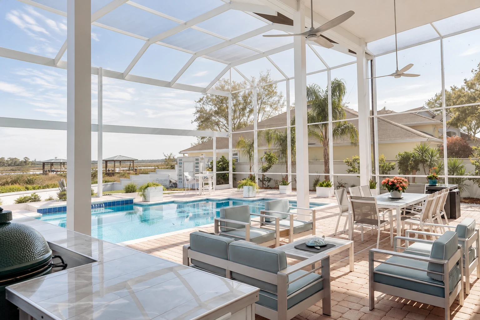 Glass-enclosed solarium with a white-framed transparent roof, pool, and outdoor dining and lounge furniture.